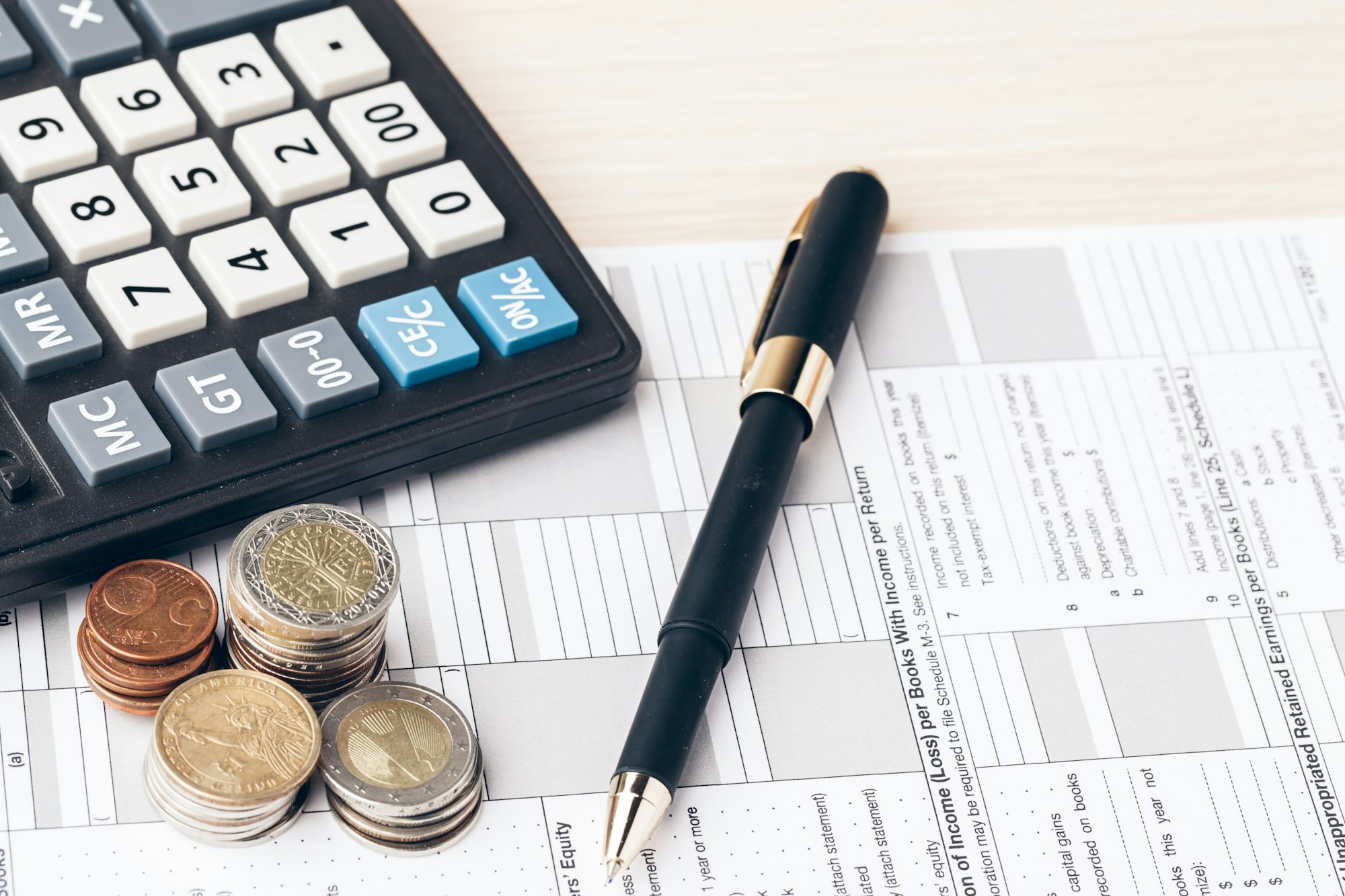 The close-up of accounting documents with money coins